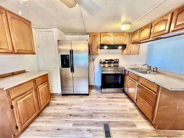 a spacious bathroom with a granite countertop sink mirror and vanity