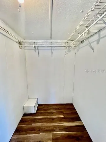 a view of a livingroom with wooden floor and staircase
