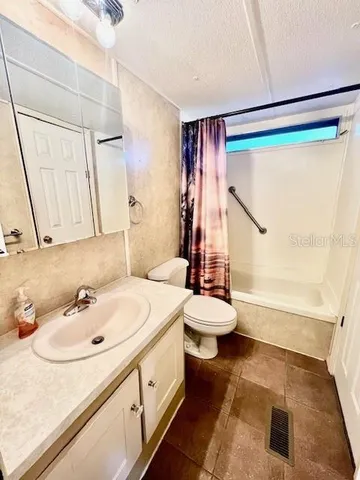 a room with a sink a washer and dryer