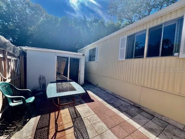 a view of backyard with wooden deck and furniture