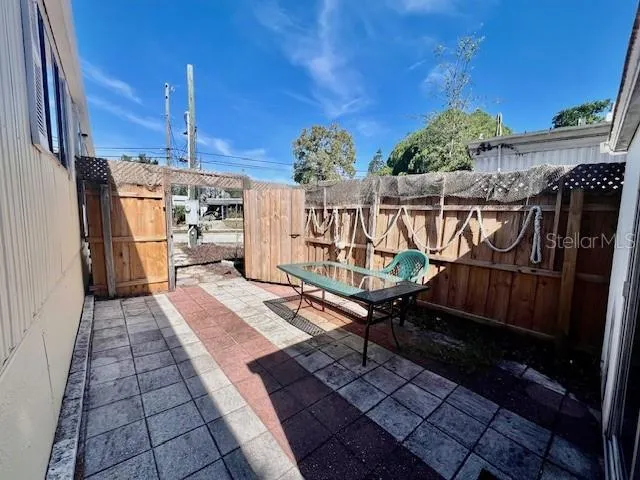 a view of a room with wooden floor and furniture