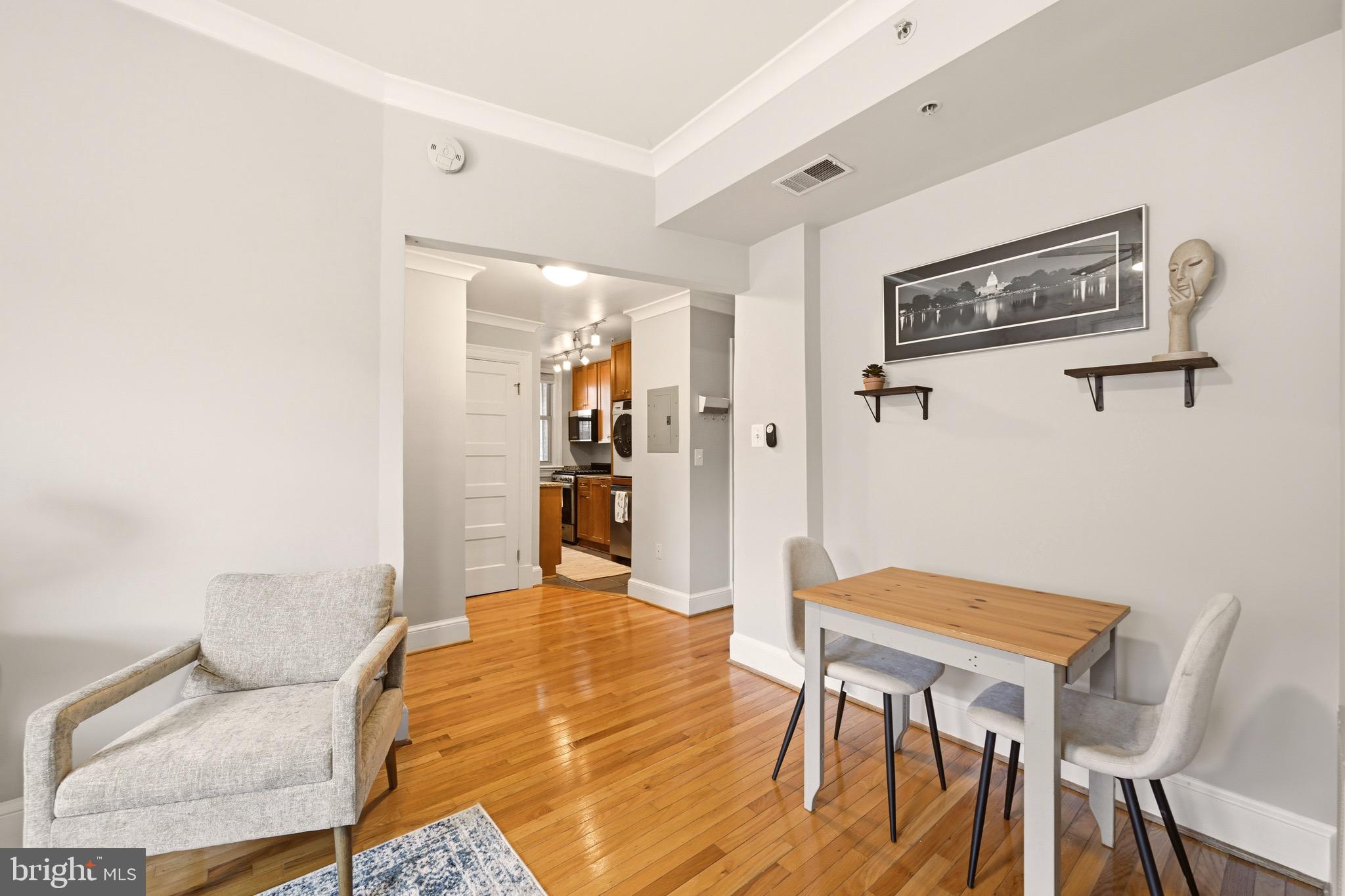 3500 13th Street Northwest, Unit 107 Washington, DC 20010 - Photo 14 of 28 a view of a livingroom with furniture and wooden floor
