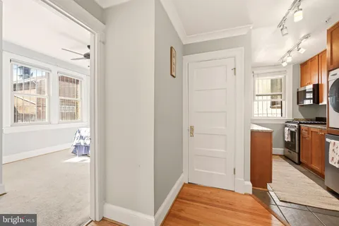 a view of walk in closet with window and bathroom