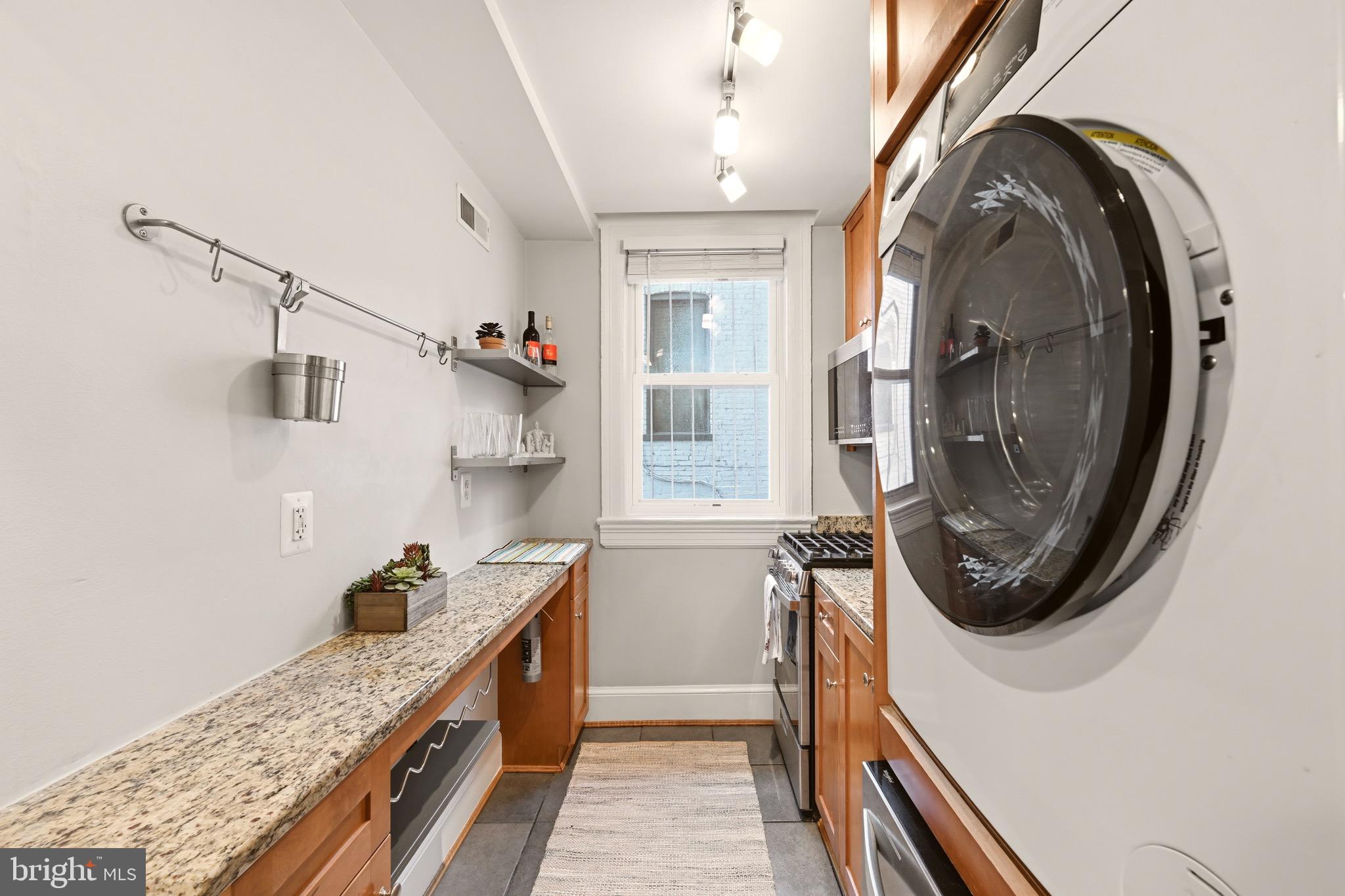 3500 13th Street Northwest, Unit 107 Washington, DC 20010 - Photo 19 of 28 a bathroom with a sink a washer and dryer