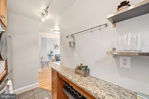 a kitchen with granite countertop a sink stainless steel appliances and cabinets