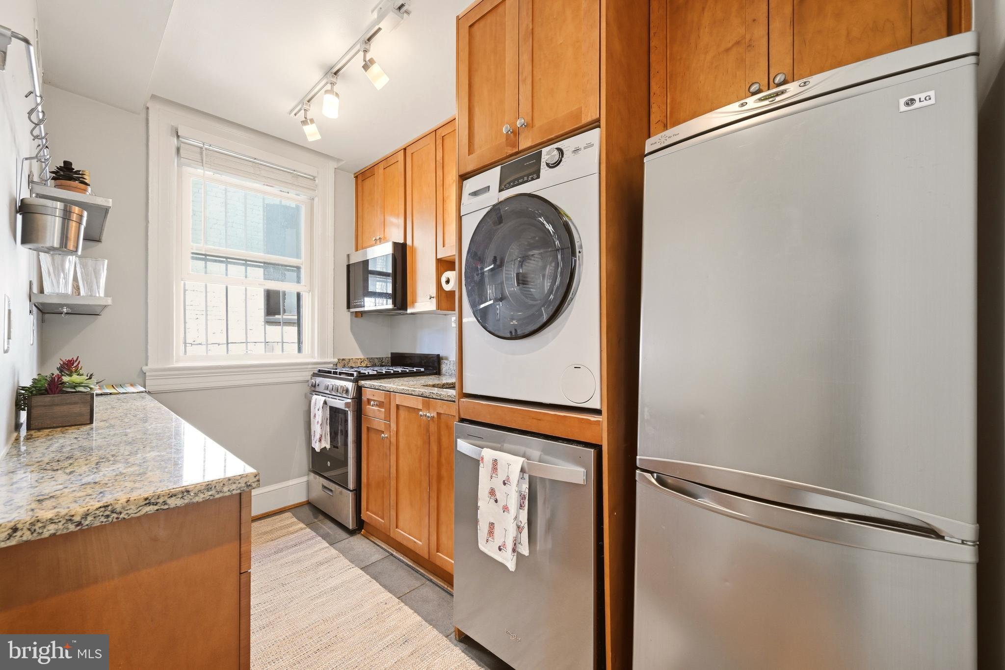 3500 13th Street Northwest, Unit 107 Washington, DC 20010 - Photo 21 of 28 a utility room with granite countertop a sink a washer and dryer