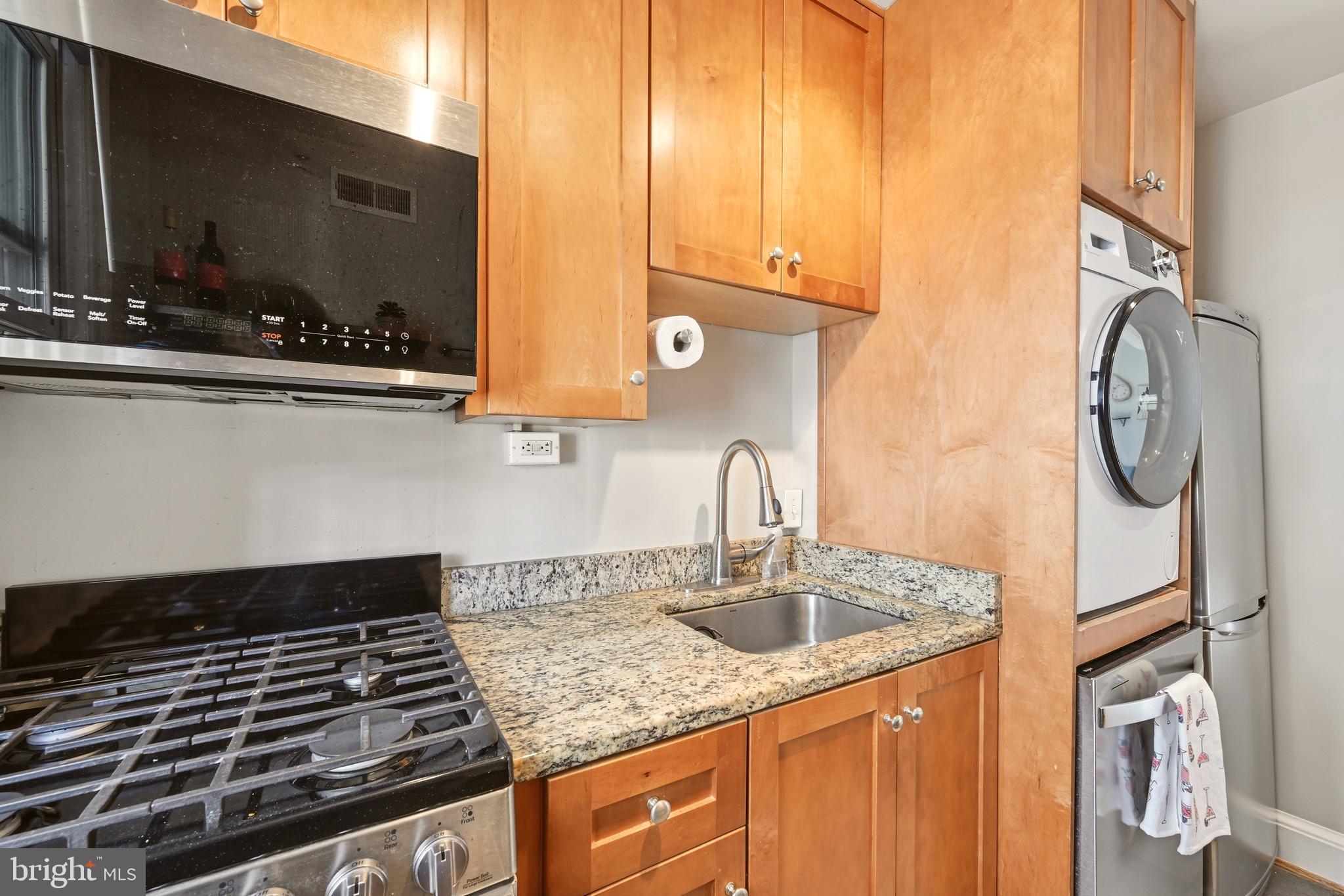 3500 13th Street Northwest, Unit 107 Washington, DC 20010 - Photo 22 of 28 a kitchen with a sink and a stove top oven