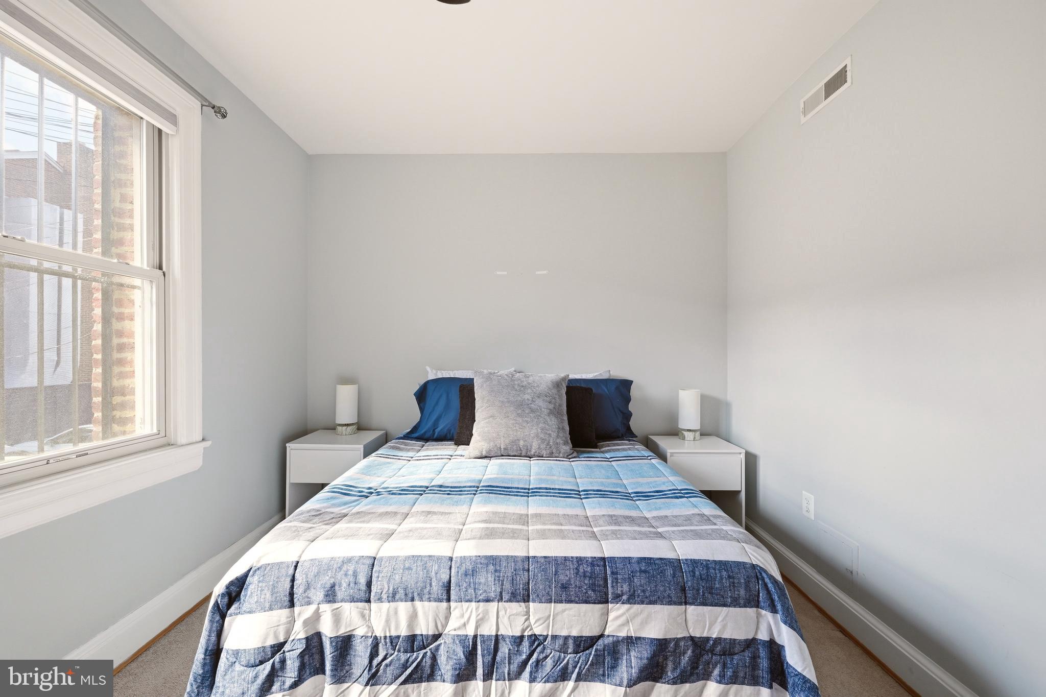 3500 13th Street Northwest, Unit 107 Washington, DC 20010 - Photo 25 of 28 a bedroom with a bed and wooden floor