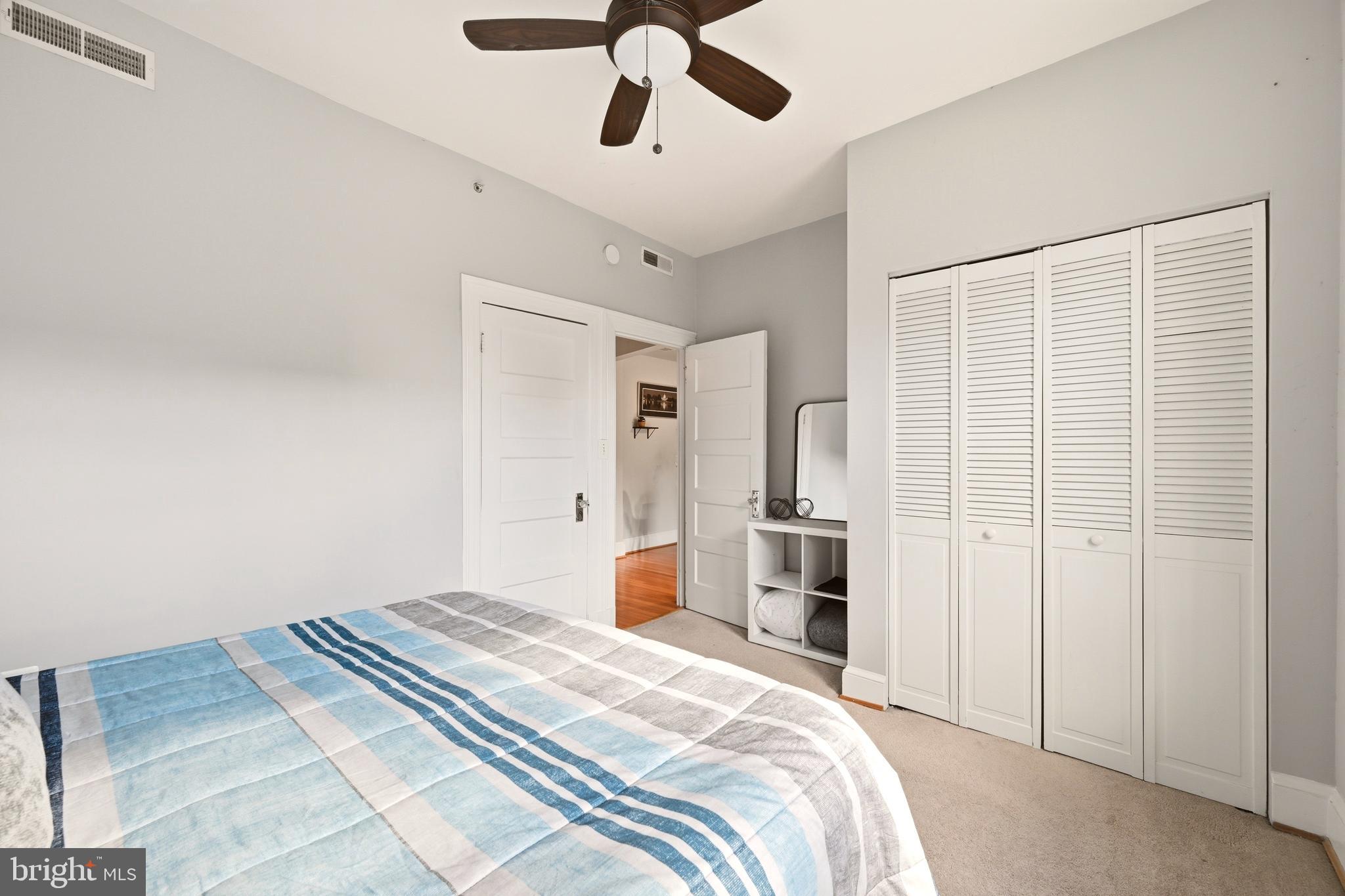 3500 13th Street Northwest, Unit 107 Washington, DC 20010 - Photo 26 of 28 a bedroom with a bed and a chandelier