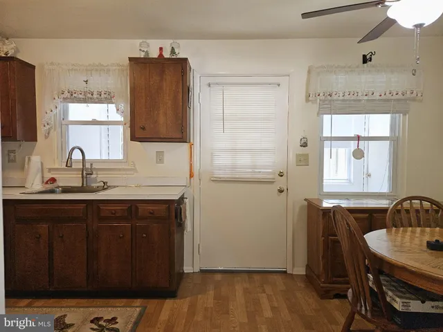 a kitchen with a sink cabinets and wooden floor