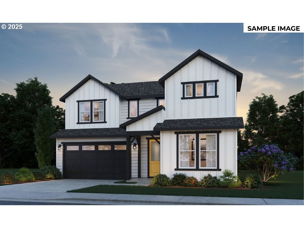 8705 South 4th Way Ridgefield, WA 98642 - Photo 1 of 26 a front view of a house with a yard and garage