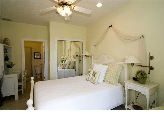 9 Blue Crab Loop Seacrest, FL 32461 - Photo 19 of 28 a bedroom with a bed and a chandelier