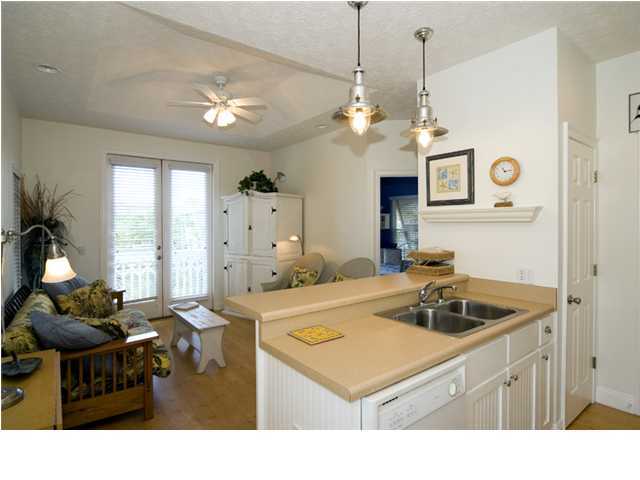 9 Blue Crab Loop Seacrest, FL 32461 - Photo 20 of 28 a kitchen with a sink a stove and a chandelier