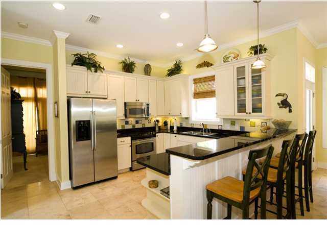 9 Blue Crab Loop Seacrest, FL 32461 - Photo 3 of 28 a kitchen with stainless steel appliances kitchen island granite countertop a sink and cabinets