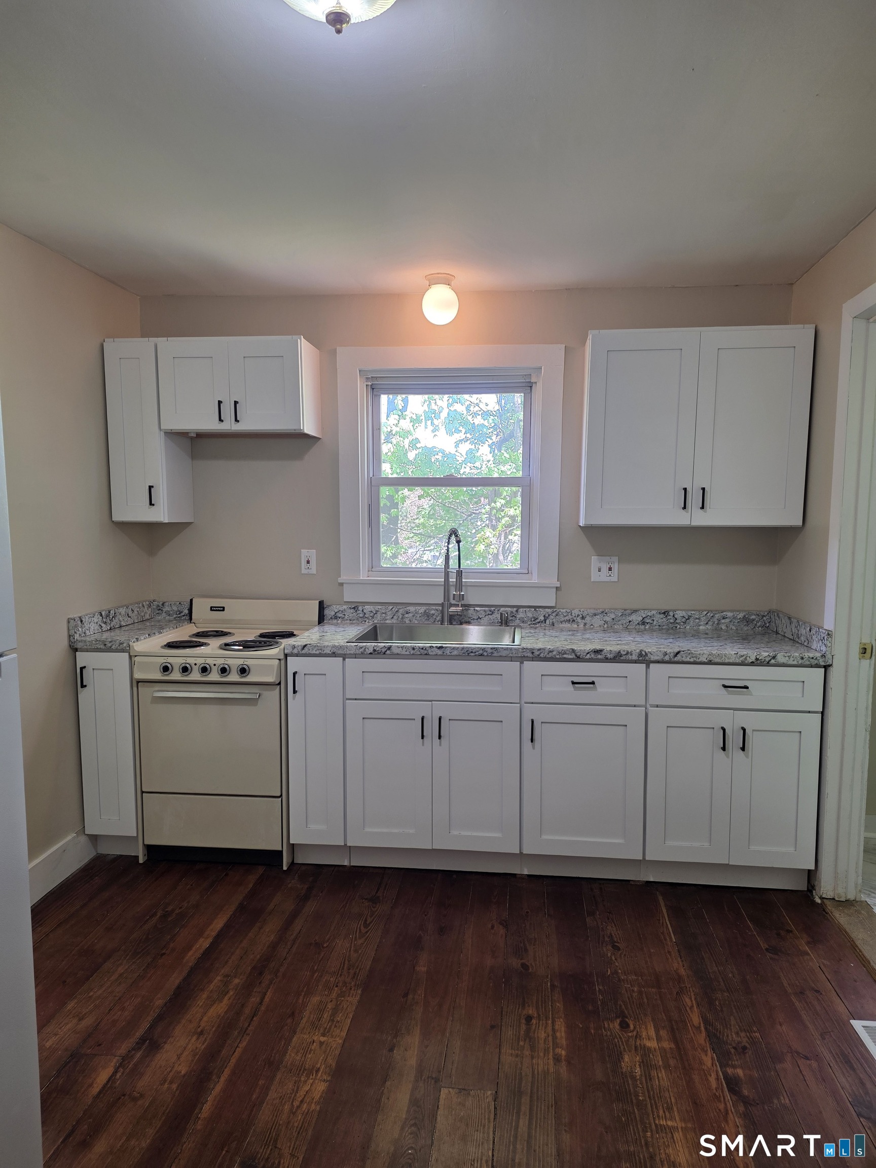 22 Lakeview Street, Unit 1 East Hampton, CT 06424 - Photo 2 of 20 a kitchen with granite countertop white cabinets and white appliances