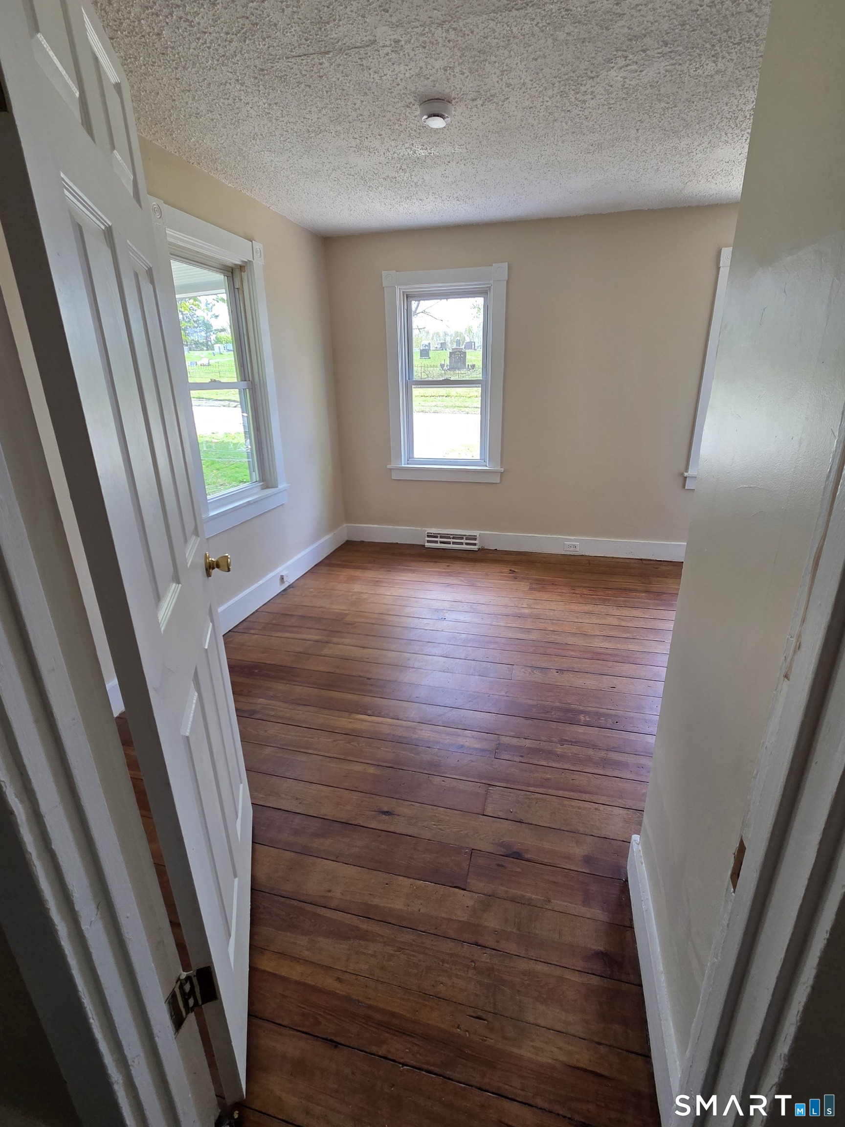 22 Lakeview Street, Unit 1 East Hampton, CT 06424 - Photo 4 of 20 a view of an empty room with wooden floor and a window