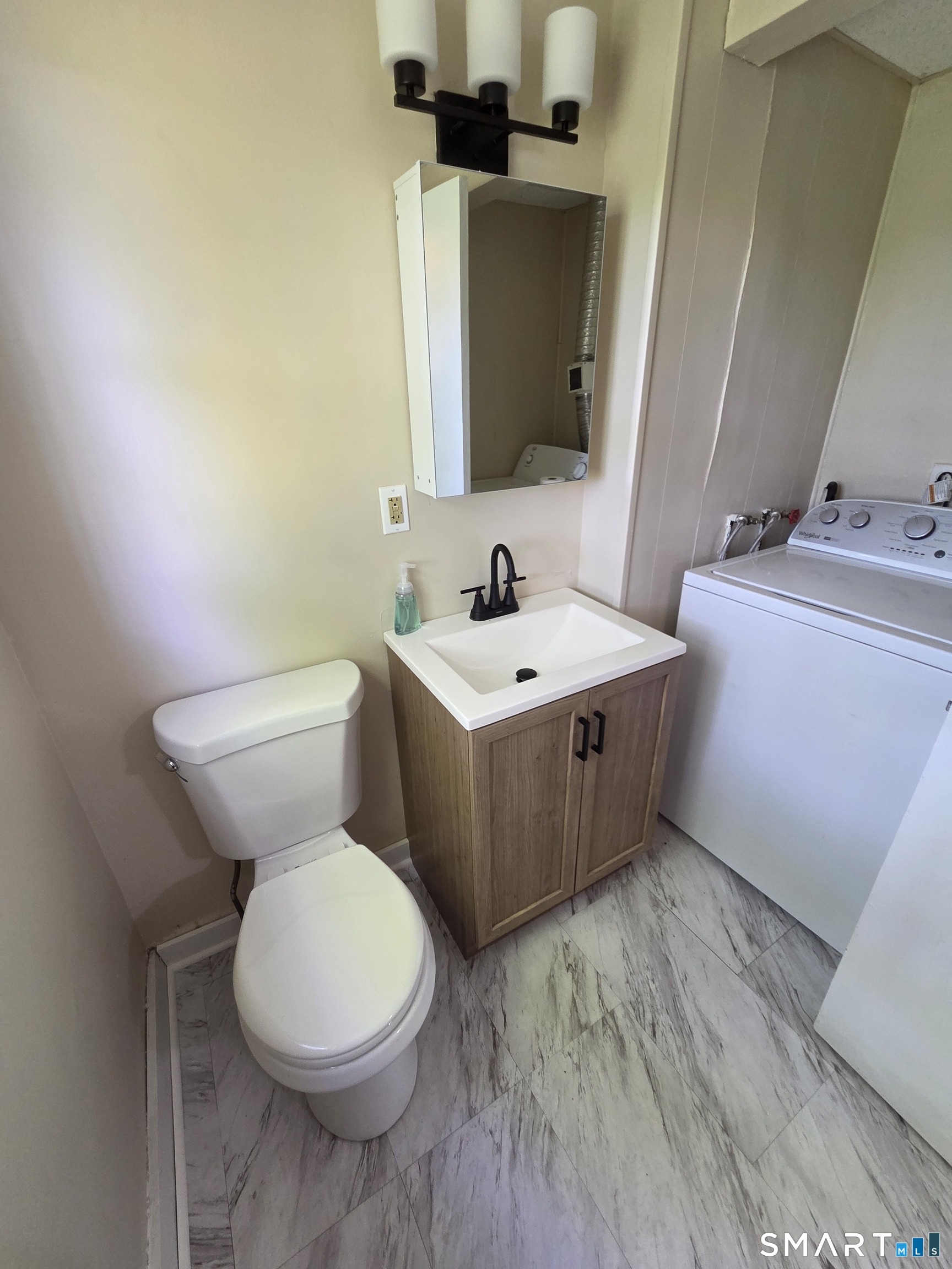 22 Lakeview Street, Unit 1 East Hampton, CT 06424 - Photo 9 of 20 a bathroom with a toilet sink and mirror