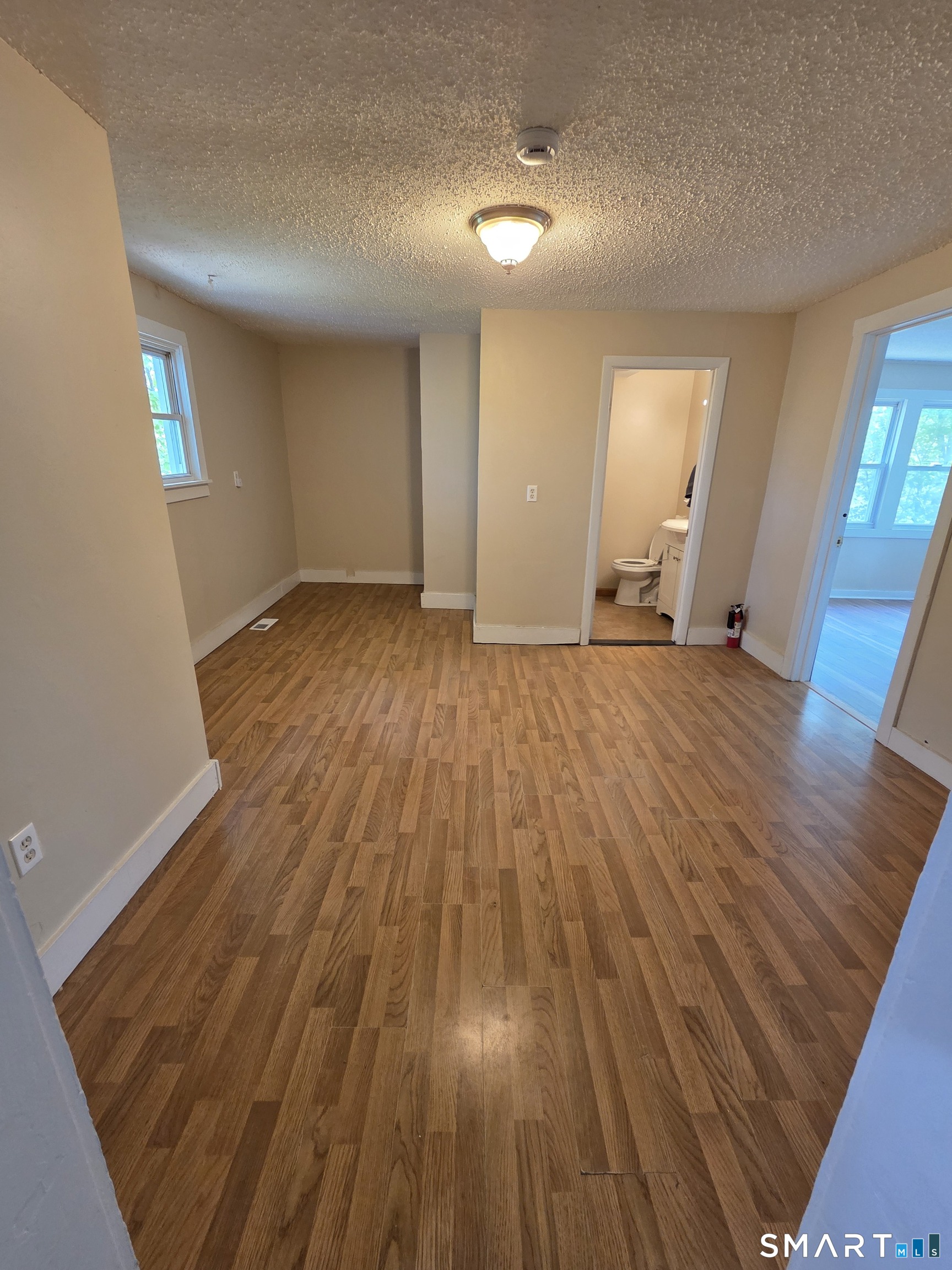 22 Lakeview Street, Unit 1 East Hampton, CT 06424 - Photo 10 of 20 wooden floor in an empty room with a window