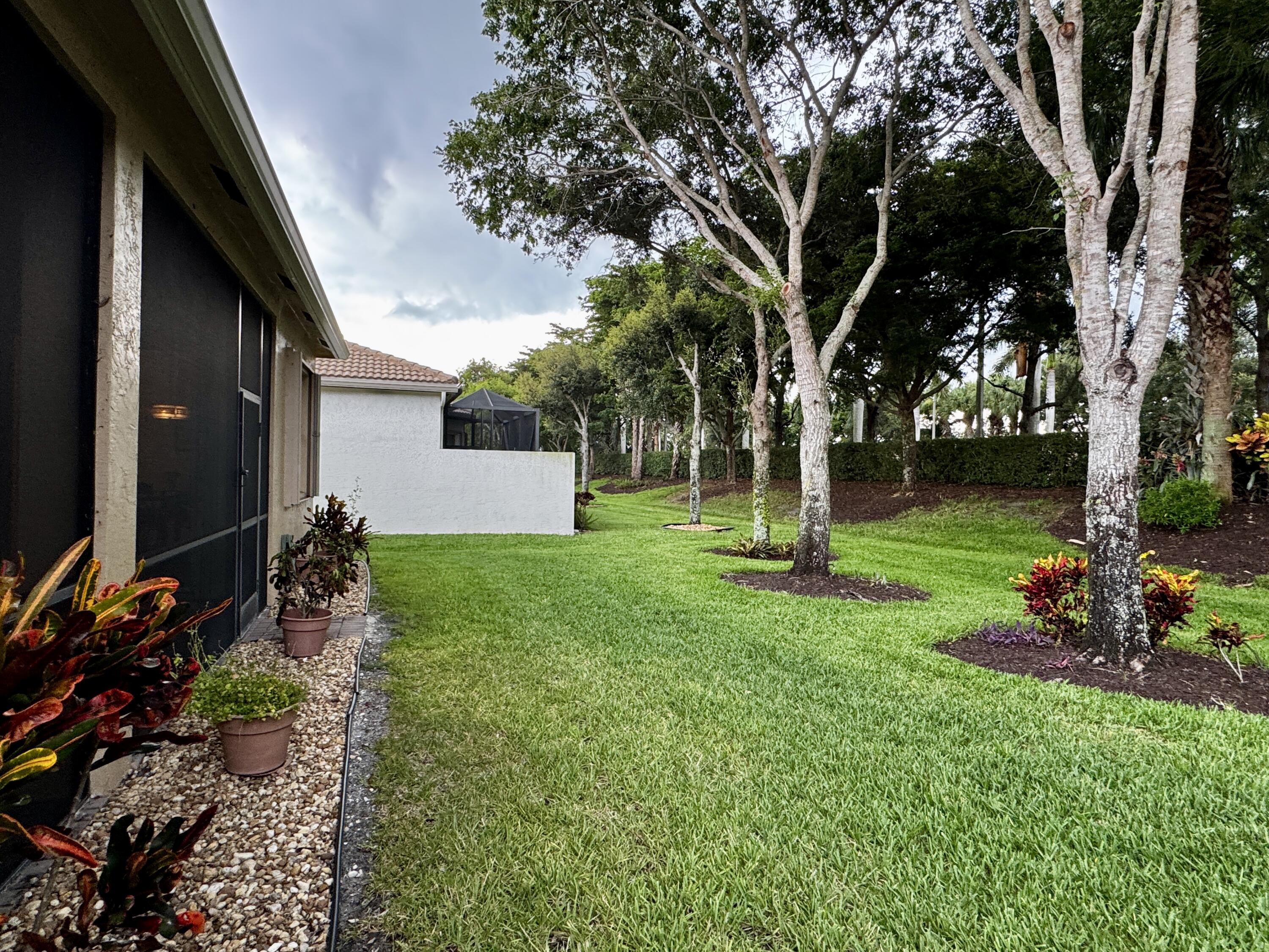 9385 Ivory Isle Road Boynton Beach, FL 33473 - Photo 18 of 50 a backyard of a house with lots of green space