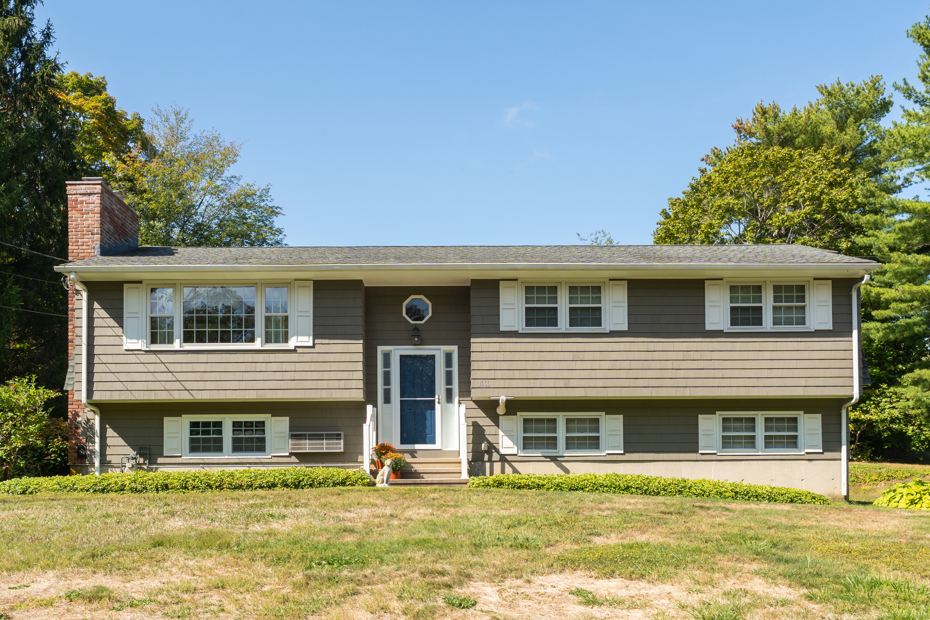 1066 Long Hill Road Guilford, CT 06437 - Photo 1 of 1 a front view of a house with a yard