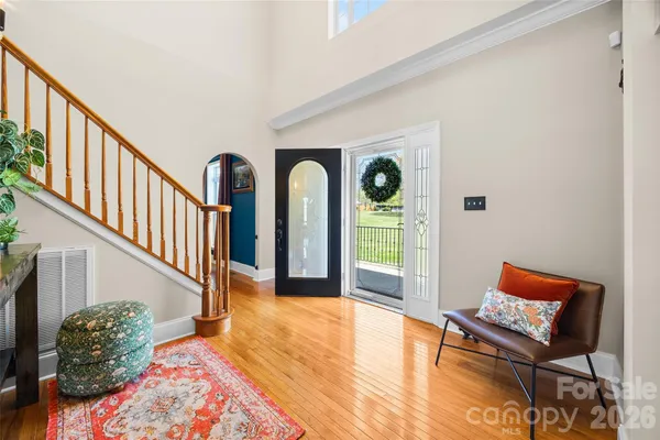 a view of entryway and hall with wooden floor