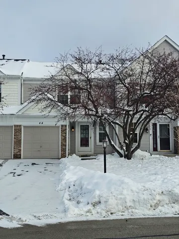 a view of a house with a snow in the yard