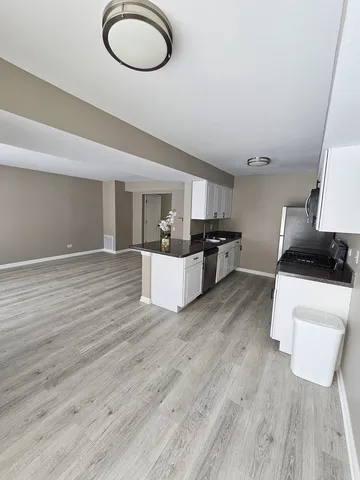 a kitchen with stainless steel appliances a stove a sink and a refrigerator