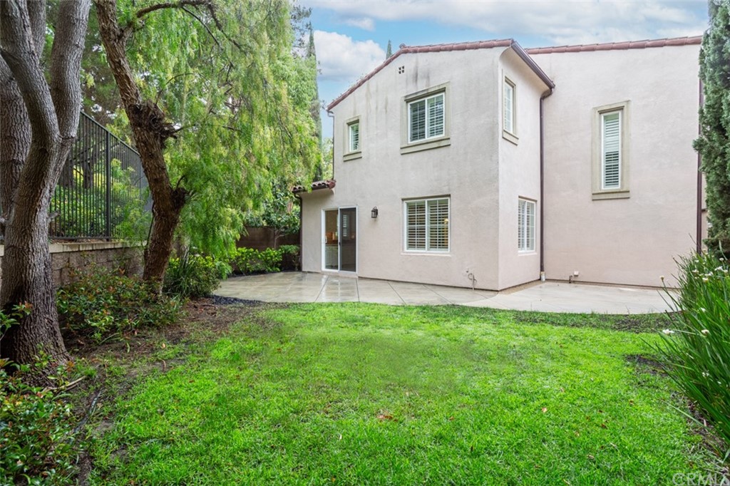 61 Bellwind Irvine, CA 92603 - Photo 11 of 17 a view of backyard with large trees and plants