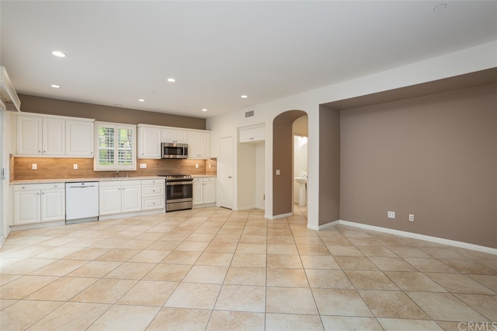 61 Bellwind Irvine, CA 92603 - Photo 2 of 17 a view of kitchen with stainless steel appliances granite countertop a refrigerator and a sink