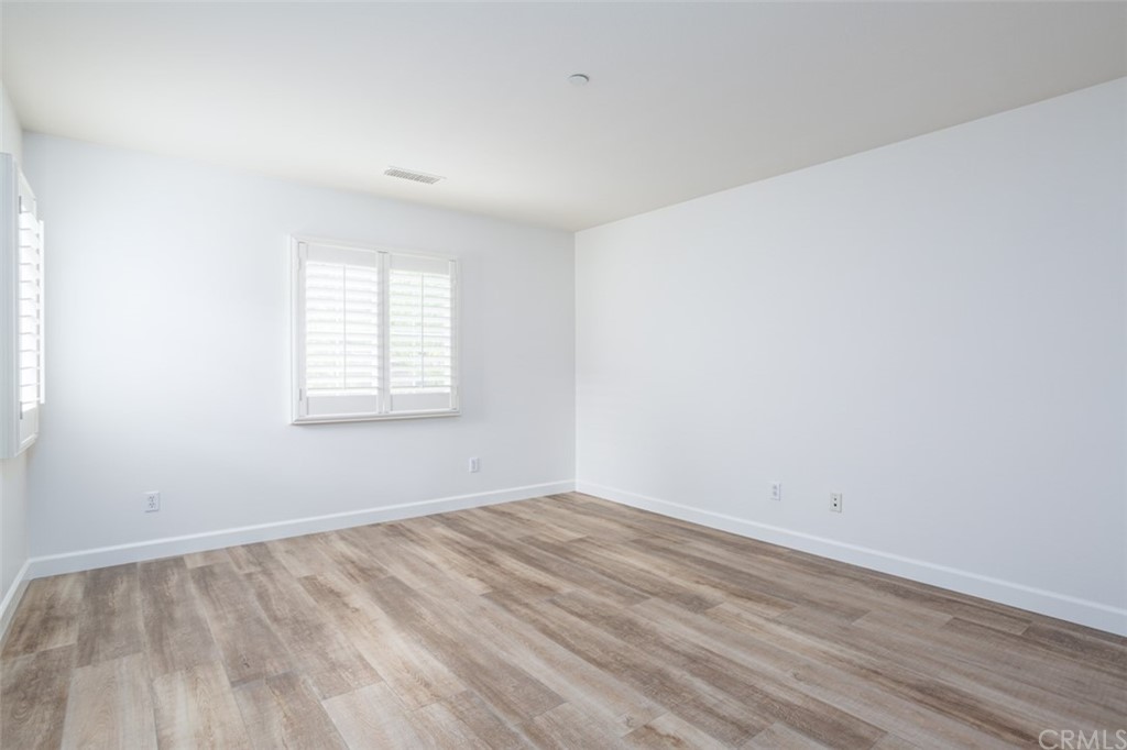 61 Bellwind Irvine, CA 92603 - Photo 3 of 17 wooden floor in an empty room with a window