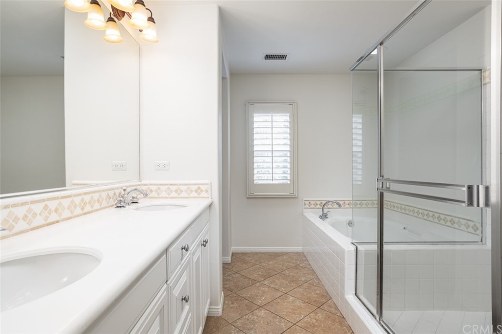 61 Bellwind Irvine, CA 92603 - Photo 4 of 17 a bathroom with a tub sink and mirror