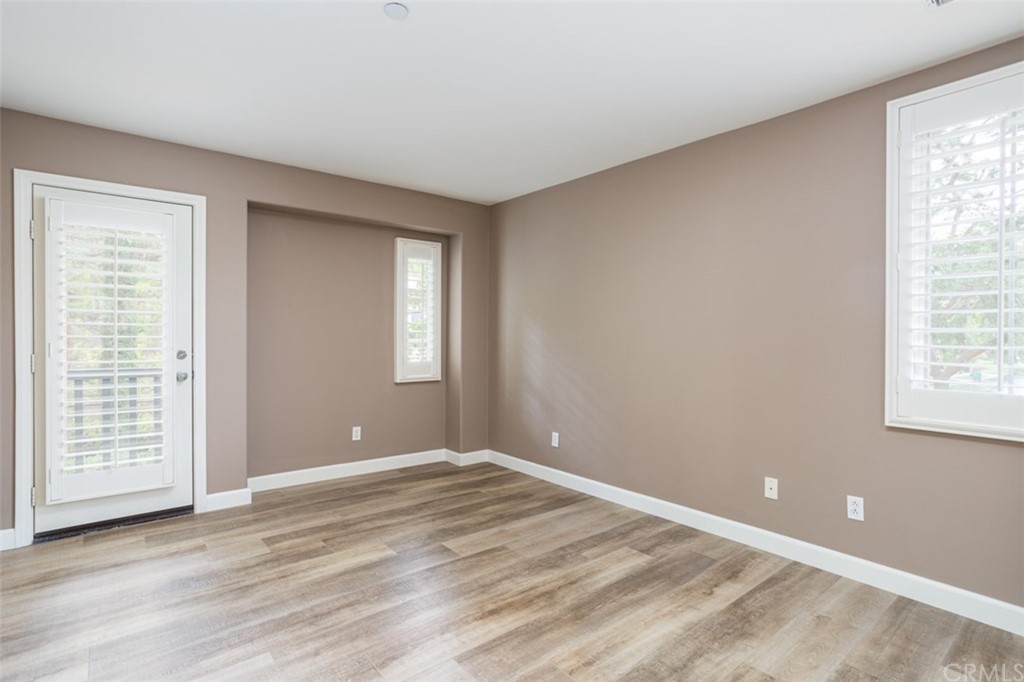 61 Bellwind Irvine, CA 92603 - Photo 7 of 17 a view of an empty room with wooden floor and a window