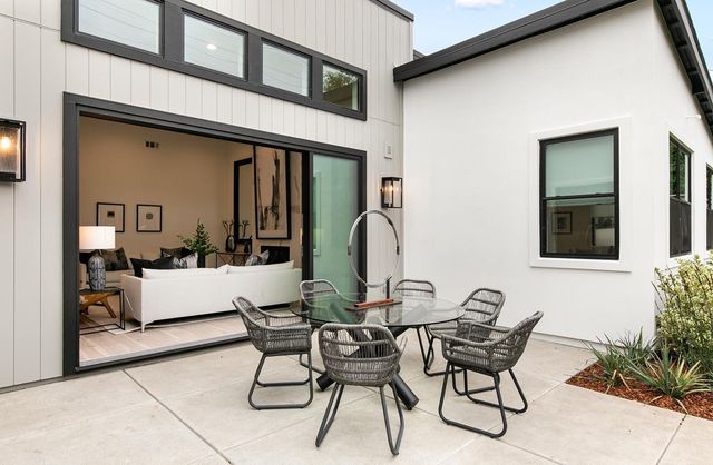 a view of a dinning room with furniture and floor to ceiling window
