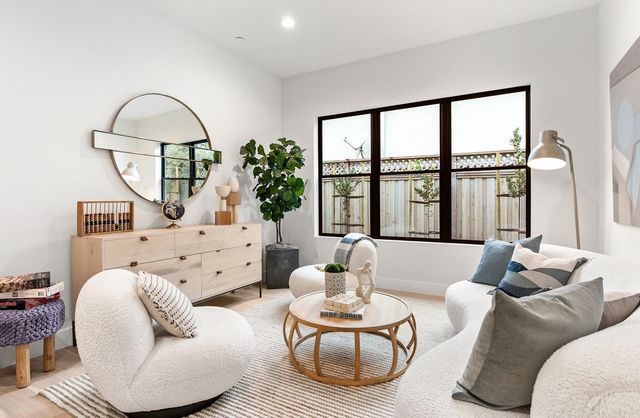 a living room with furniture a window and a dining table