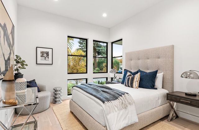 a bedroom with a bed and a painting on the wall