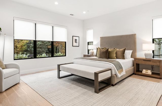 a bedroom with a bed and lamp