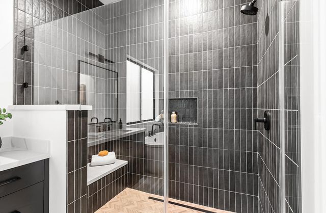 a bedroom with a large bed and a wooden floor