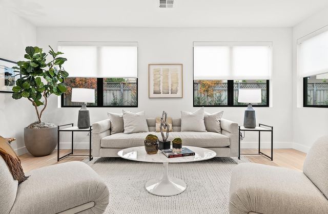 a kitchen with white cabinets and sink
