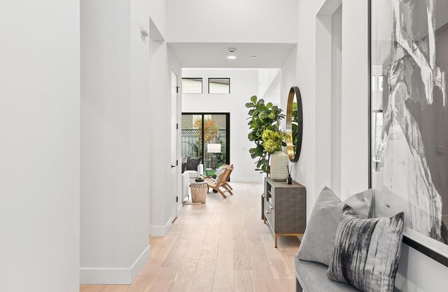 a living room with furniture and a potted plant