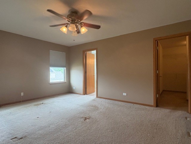 211 Leah Court Sycamore, IL 60178 - Photo 24 of 29 an empty room with a chandelier fan and windows