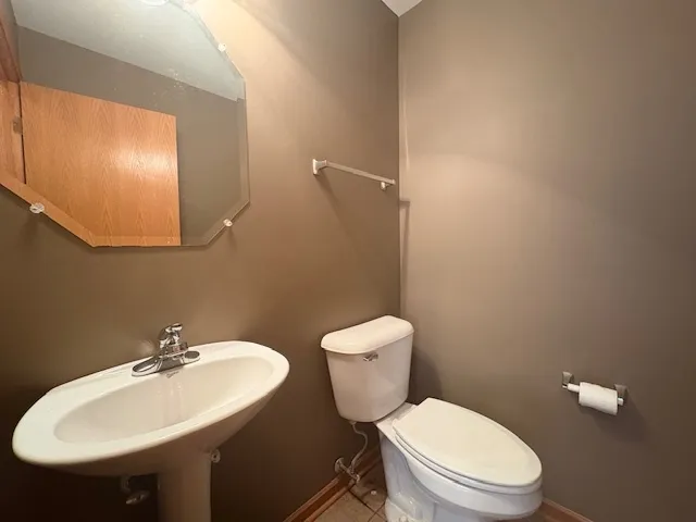 a white toilet sitting next to a bathroom sink