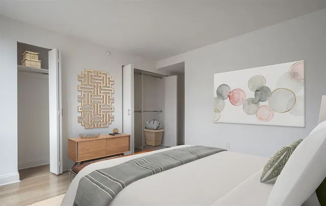 a bedroom with a bed and a painting on the wall