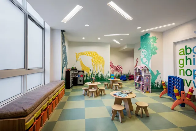 a room with lots of white furniture and painting on the wall