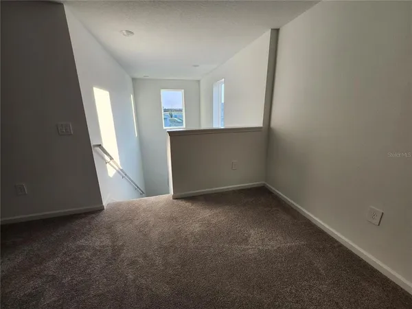 an empty room with a empty space and a window