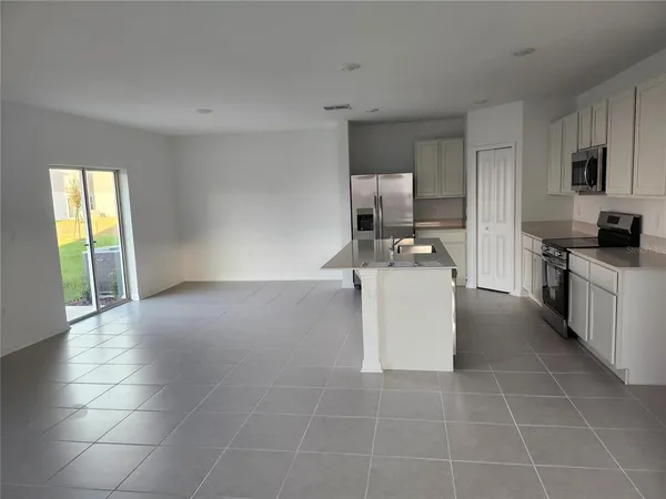 a view of a kitchen with furniture and window
