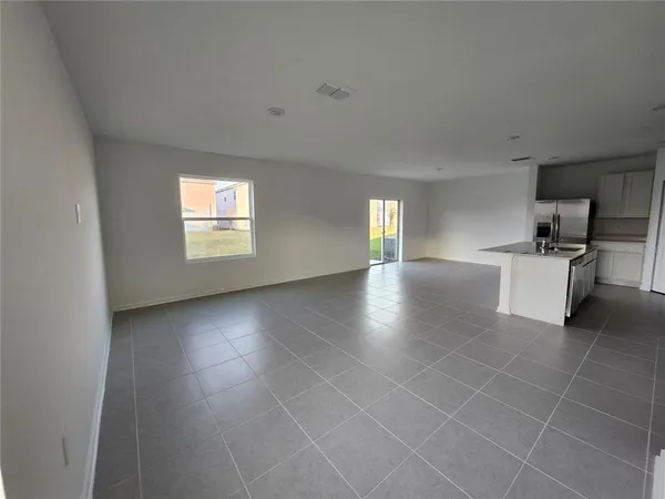 a large kitchen with cabinets and stainless steel appliances