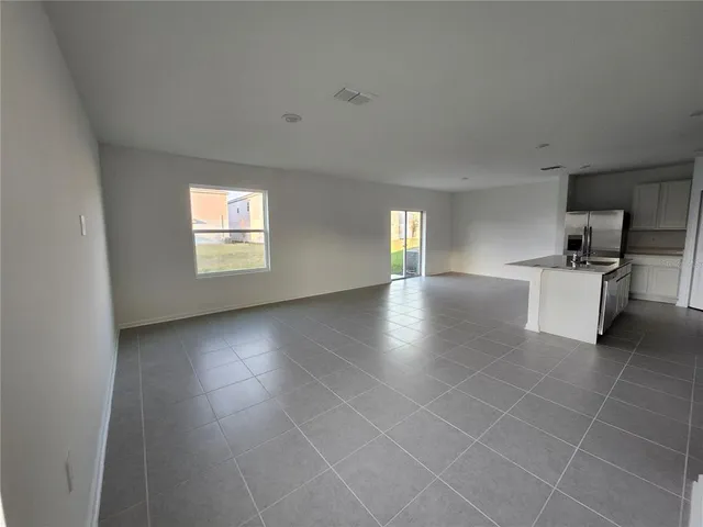 a large kitchen with cabinets and stainless steel appliances