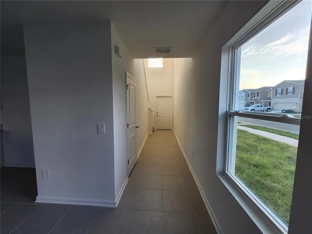 a kitchen with a sink a refrigerator and window