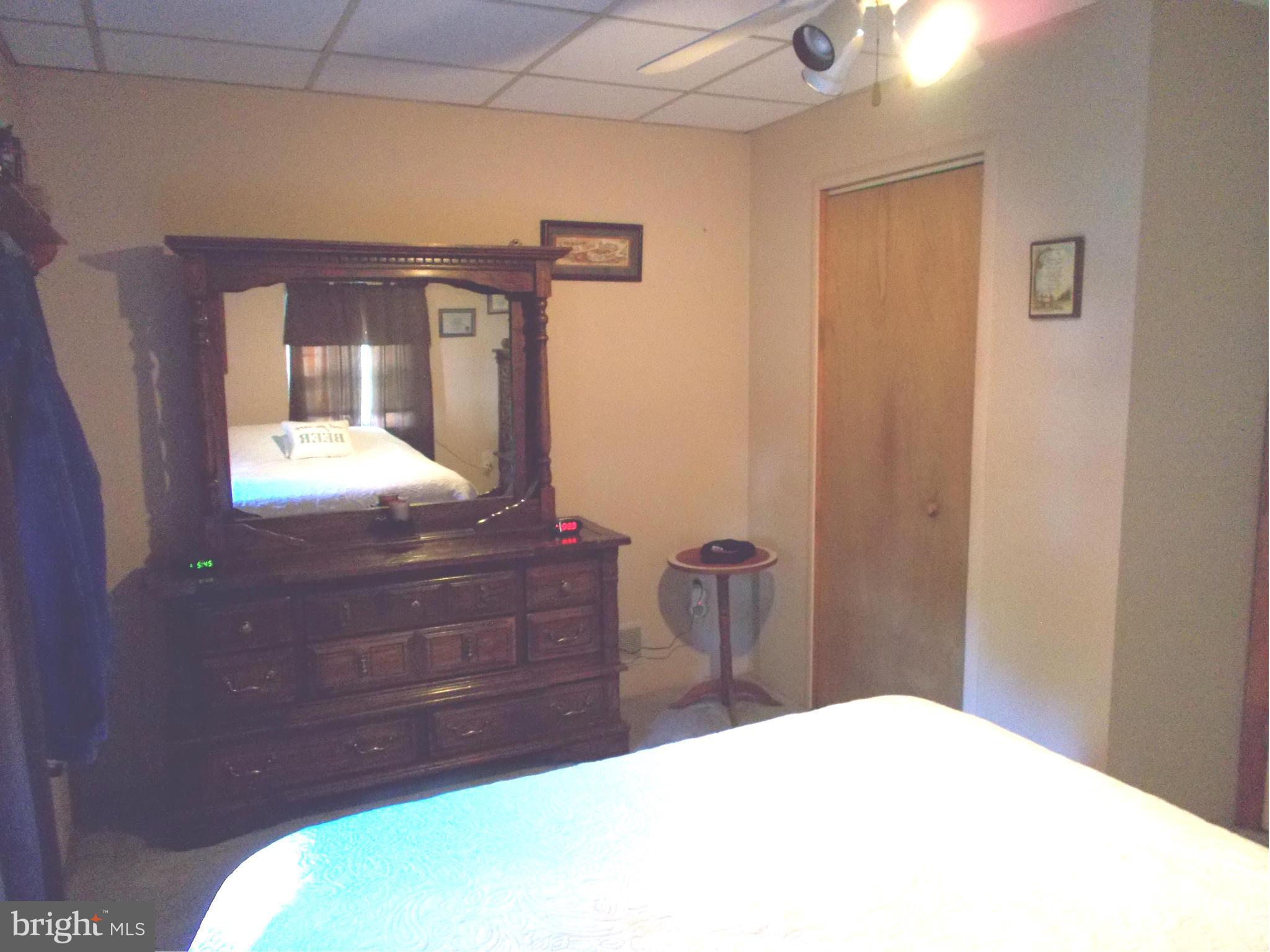 24850 Pen Mar Road Cascade, MD 21719 - Photo 14 of 27 a bedroom with a bed and a dresser