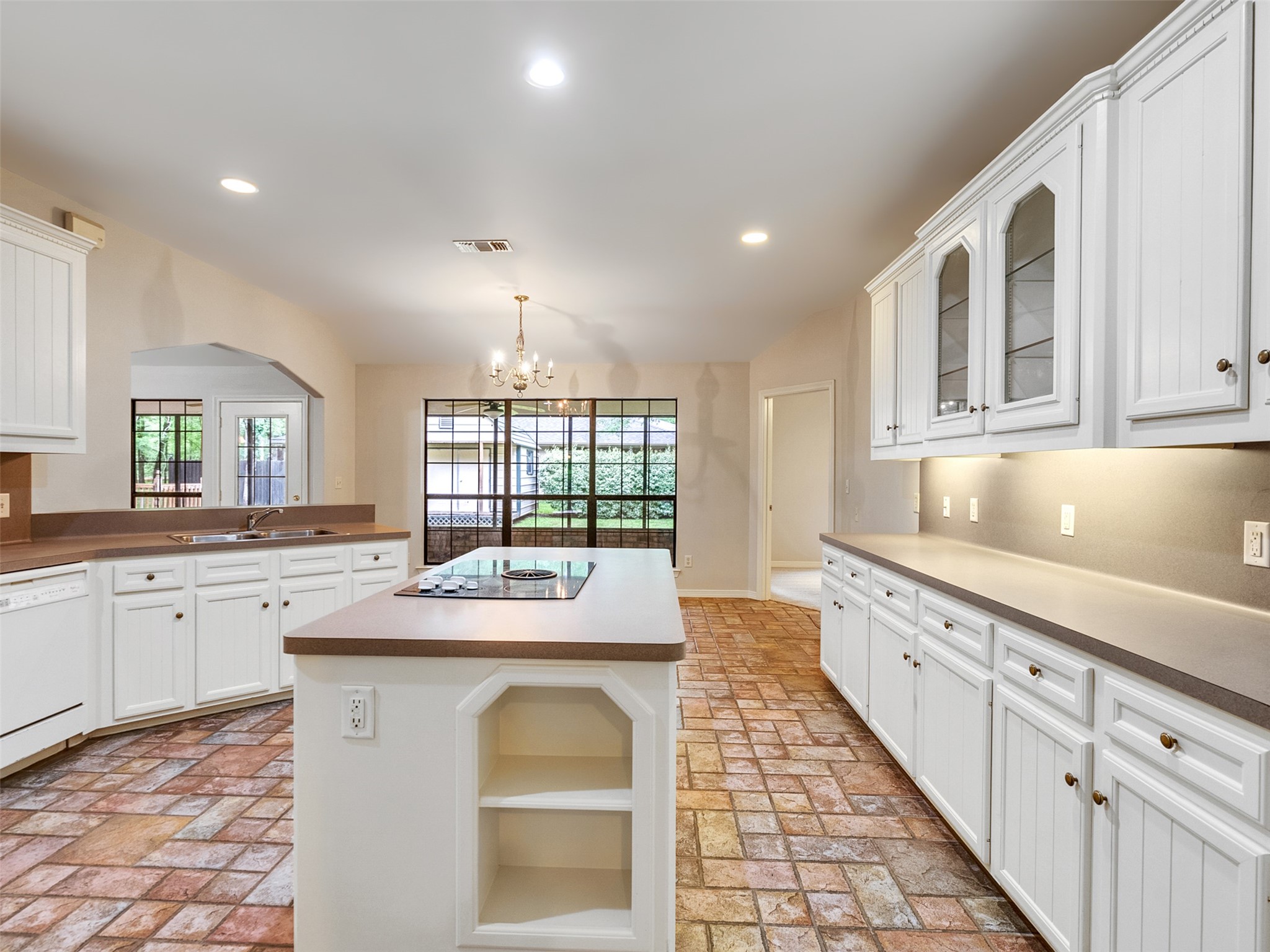 195 Coral Gables Trinity, TX 75862 - Photo 13 of 50 a kitchen with stainless steel appliances granite countertop a sink and dishwasher with a large window